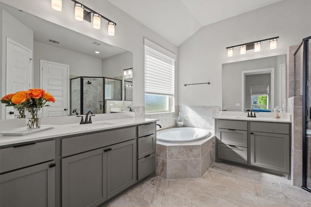 bathroom with a sink, a stall shower, a garden tub, and visible vents
