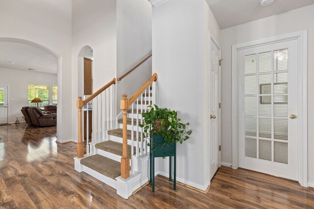 117 Summers Grn, Georgetown, TX 78633 - staircase featuring arched walkways, wood finished floors, and baseboards