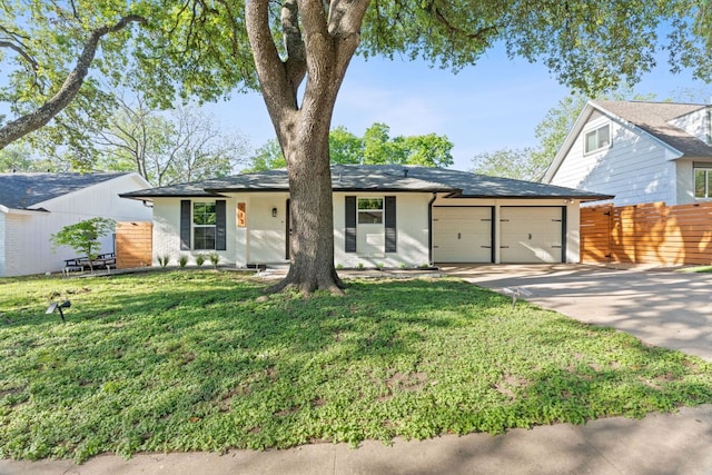 713 Buckingham Pl, Austin, TX 78745 - view of front facade featuring a front lawn, fence, brick siding, concrete driveway, and an attached garage