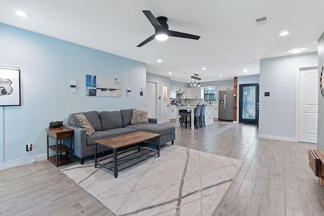 713 Buckingham Pl, Austin, TX 78745 - living area featuring visible vents, light wood-style floors, ceiling fan, and baseboards