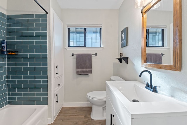 713 Buckingham Pl, Austin, TX 78745 - bathroom featuring vanity, toilet, baseboards, shower / washtub combination, and wood finished floors