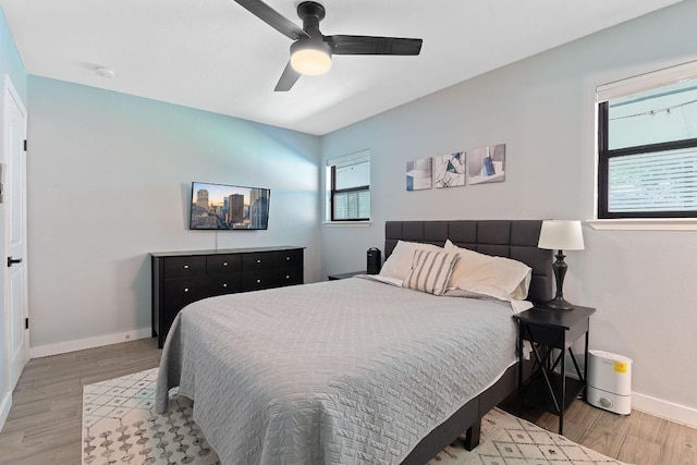 713 Buckingham Pl, Austin, TX 78745 - bedroom featuring baseboards, a ceiling fan, and light wood finished floors