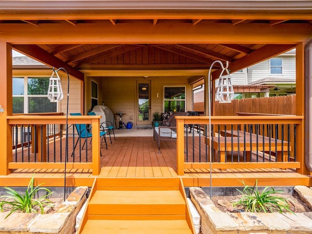 deck featuring fence and covered porch