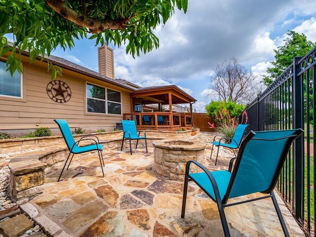view of patio featuring a fenced backyard and an outdoor fire pit