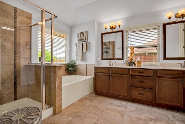 bathroom featuring double vanity, a sink, a bath, and a stall shower