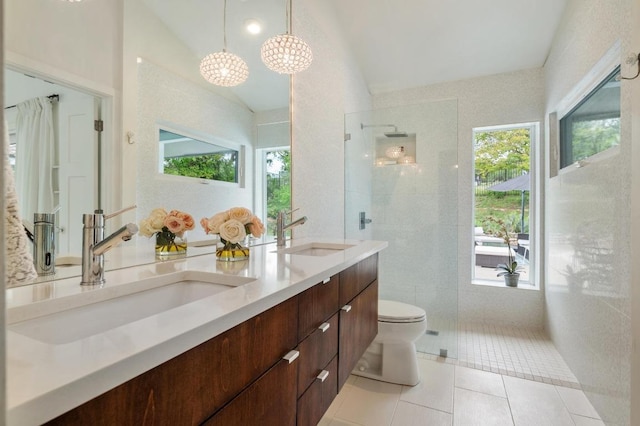 full bath with plenty of natural light, a sink, and tiled shower
