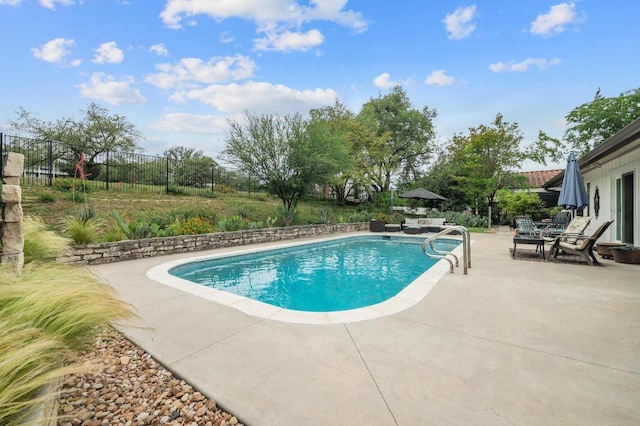 view of swimming pool featuring fence, a fenced in pool, and a patio