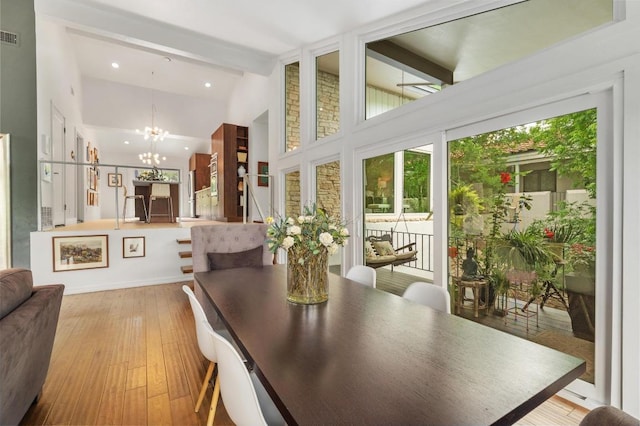 419 Sunfish St, Lakeway, TX 78734 - dining room featuring a chandelier, beam ceiling, light wood-style floors, high vaulted ceiling, and recessed lighting