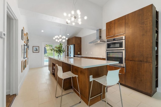 kitchen with an inviting chandelier, wall chimney range hood, light countertops, a sink, and vaulted ceiling