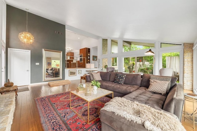 419 Sunfish St, Lakeway, TX 78734 - living area featuring hardwood / wood-style flooring, a chandelier, high vaulted ceiling, and beamed ceiling