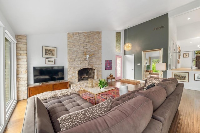 419 Sunfish St, Lakeway, TX 78734 - living area with high vaulted ceiling, light wood-style flooring, and a stone fireplace