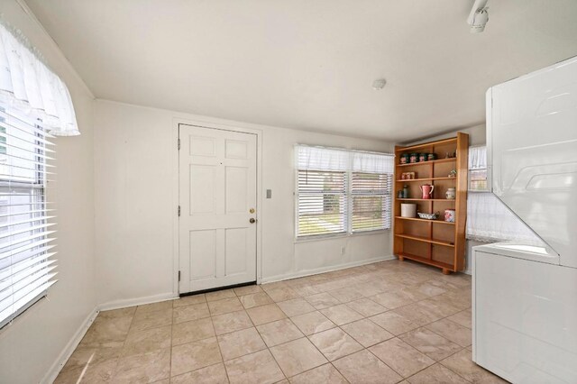 interior space featuring light tile patterned floors and baseboards