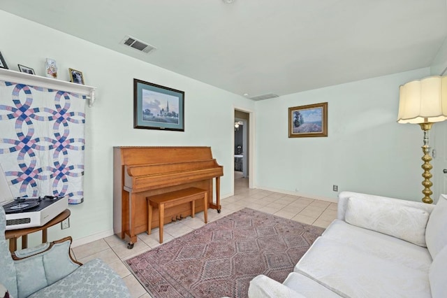 living room with baseboards, visible vents, and light tile patterned floors
