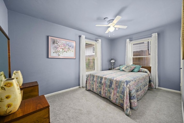 carpeted bedroom with baseboards and ceiling fan