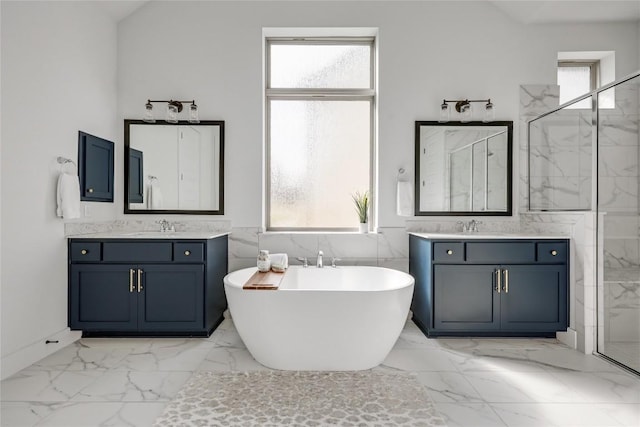 bathroom with a sink, marble finish floor, and a wealth of natural light