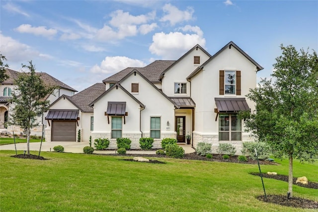 modern inspired farmhouse featuring an attached garage, stone siding, a front yard, concrete driveway, and a standing seam roof