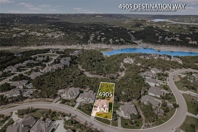 birds eye view of property with a water view and a residential view