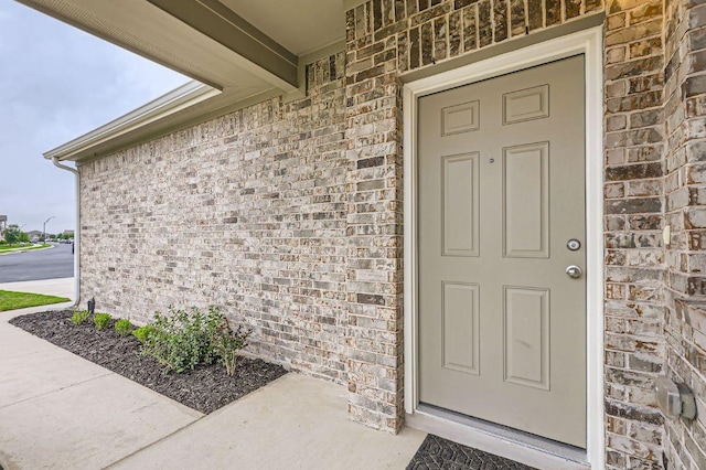 property entrance with brick siding