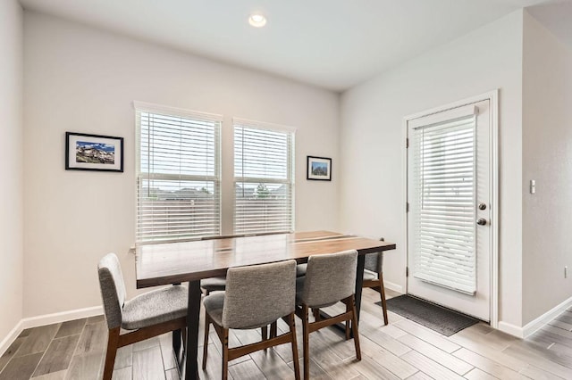 dining space with recessed lighting, baseboards, and light wood-type flooring