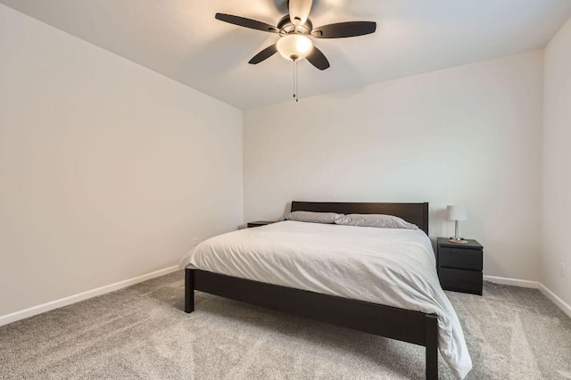 carpeted bedroom featuring baseboards and a ceiling fan