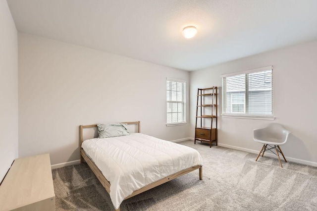 carpeted bedroom featuring baseboards