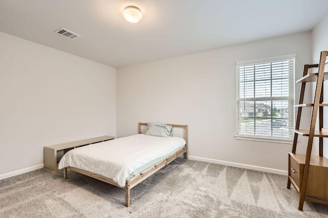 carpeted bedroom with visible vents and baseboards