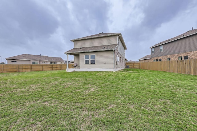 back of house featuring a patio, a fenced backyard, and a yard