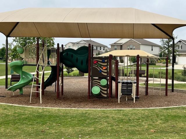 community jungle gym with a yard