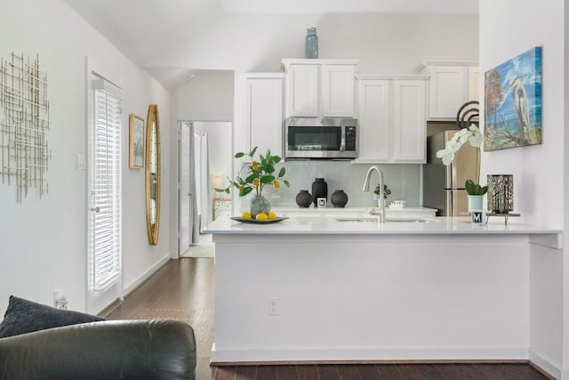 173 Venti Cv, Georgetown, TX 78628 - kitchen with backsplash, dark wood-style flooring, a sink, white cabinets, and stainless steel appliances