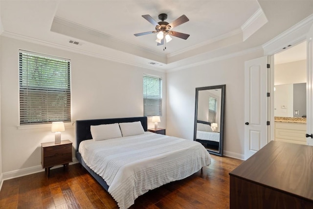 bedroom featuring crown molding, visible vents, dark wood-style floors, and a raised ceiling