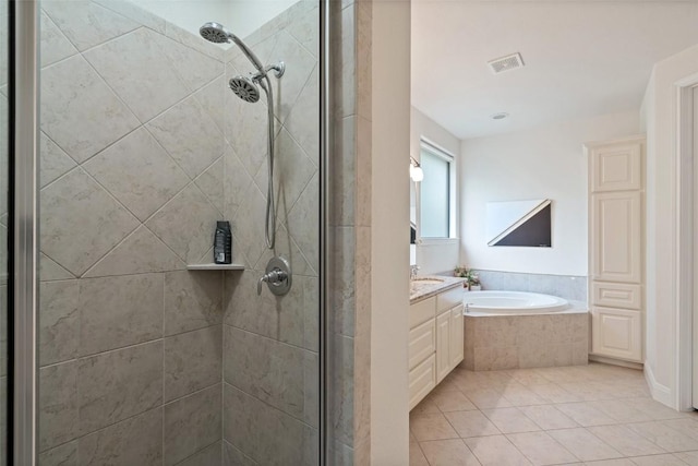 bathroom with vanity, a shower stall, a garden tub, and visible vents