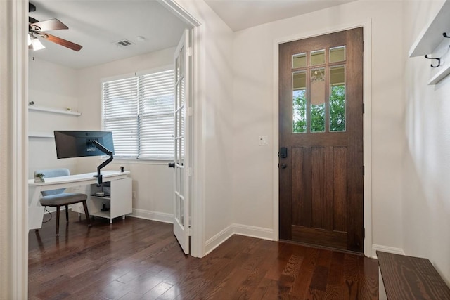 foyer featuring a wealth of natural light, a ceiling fan, dark wood-style floors, and visible vents