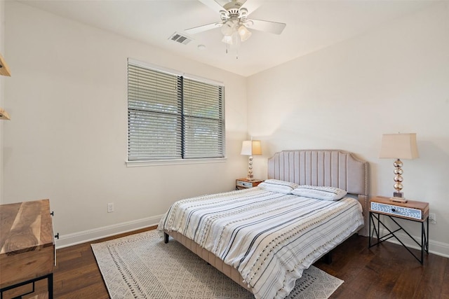 bedroom with baseboards, ceiling fan, wood-type flooring, and visible vents