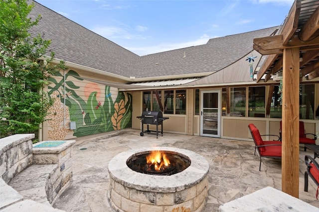 view of patio / terrace with a grill and an outdoor fire pit