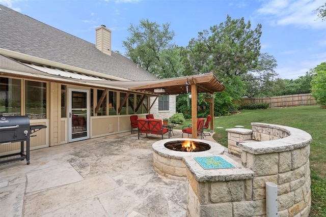 view of patio / terrace with a grill, fence, and an outdoor fire pit