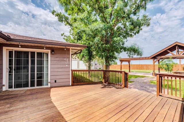 wooden terrace featuring fence