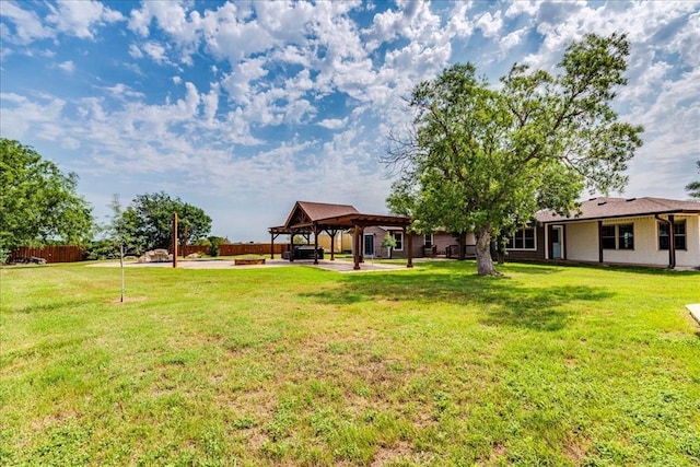 view of yard with a gazebo, fence, and a patio area