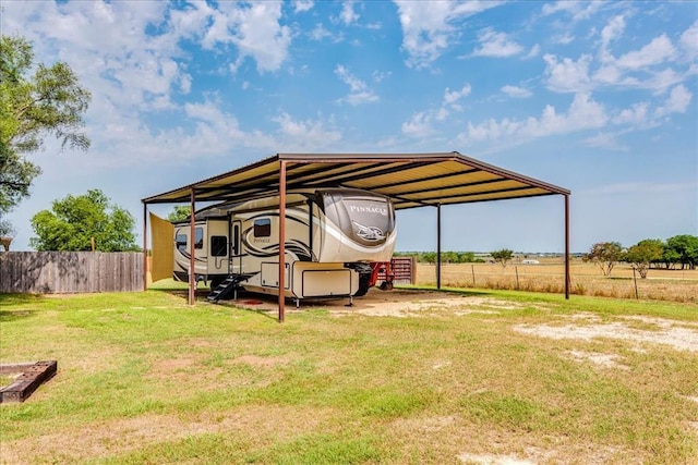view of car parking featuring fence, driveway, and a carport