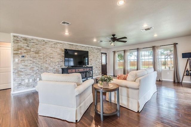 living room featuring a ceiling fan, baseboards, visible vents, and dark wood-style floors