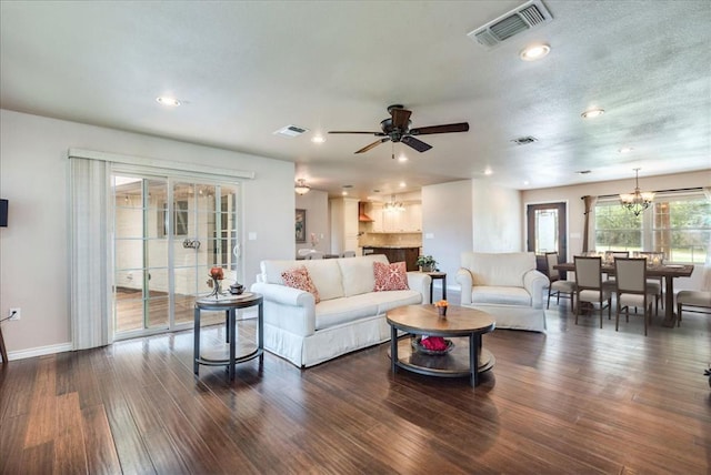 living area featuring recessed lighting, baseboards, visible vents, and dark wood finished floors