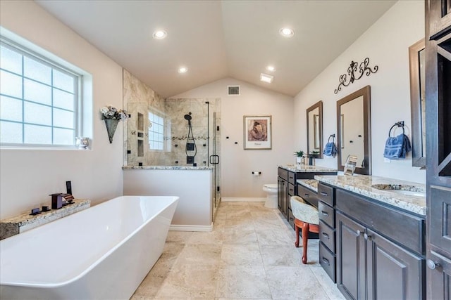 bathroom featuring two vanities, a shower stall, lofted ceiling, visible vents, and a soaking tub