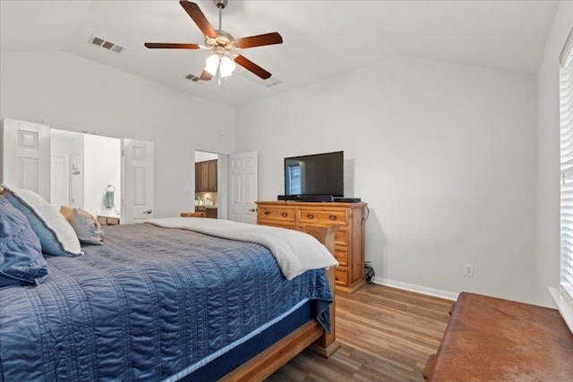 bedroom featuring visible vents, a ceiling fan, baseboards, wood finished floors, and vaulted ceiling
