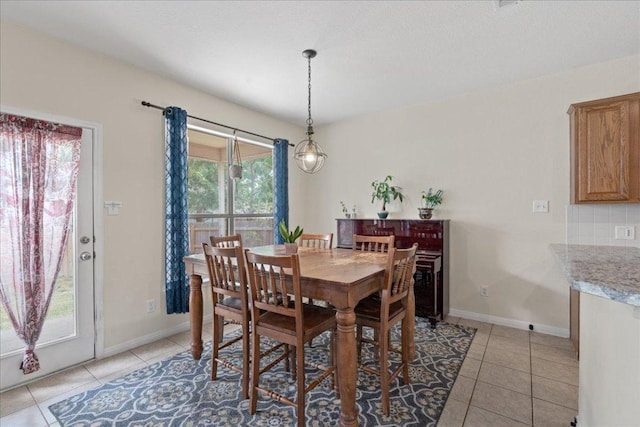dining area featuring baseboards and light tile patterned flooring