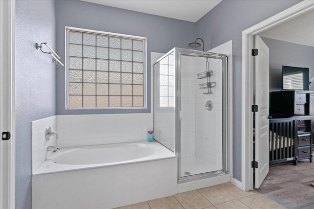 2302 Wheaton Trl, Cedar Park, TX 78613 - bathroom featuring a bath, a stall shower, and tile patterned floors