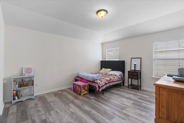 bedroom featuring light wood-style floors and baseboards