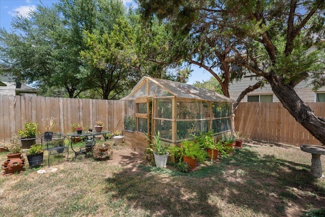 2302 Wheaton Trl, Cedar Park, TX 78613 - fenced backyard featuring a greenhouse and an outbuilding