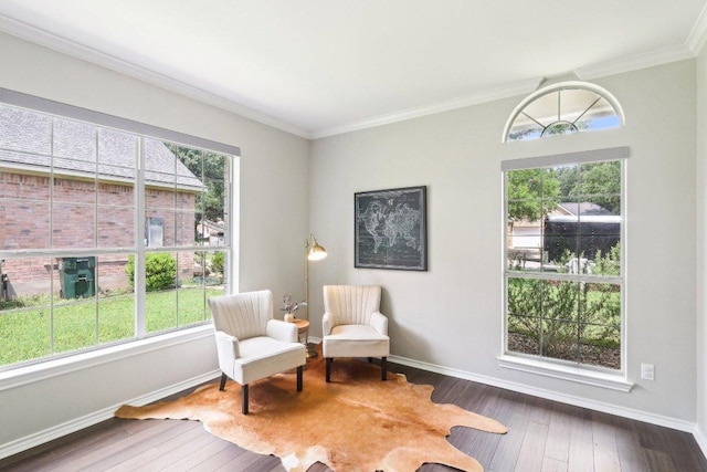 living area with plenty of natural light, wood-type flooring, and crown molding
