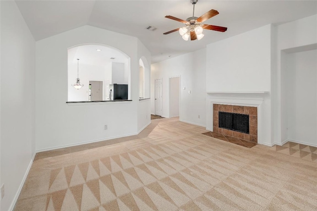 unfurnished living room with carpet floors, ceiling fan, visible vents, and lofted ceiling
