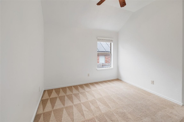 spare room featuring baseboards, ceiling fan, lofted ceiling, and light colored carpet