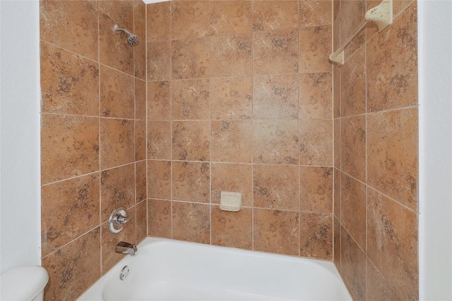bathroom with toilet and tub / shower combination